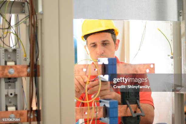 electrician working on a circuit board - amperage stock pictures, royalty-free photos & images