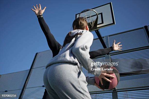 outdoor urban basketball training session between male father coach and female daughter player - sports training drill stock pictures, royalty-free photos & images