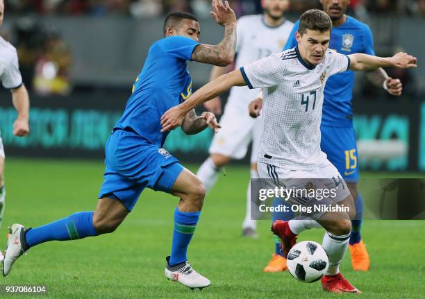 Roman Zobnin of Russia vies for the ball with Gabriel Jesus of Brazil during the International friendly match between Russia and Brazil at Luzhniki...