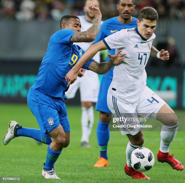 Roman Zobnin of Russia vies for the ball with Gabriel Jesus of Brazil during the International friendly match between Russia and Brazil at Luzhniki...