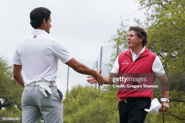 Phil Mickelson of the United States shakes hands with Rafa Cabrera Bello of Spain after defeating him 1up on the 18th green during the third round of...