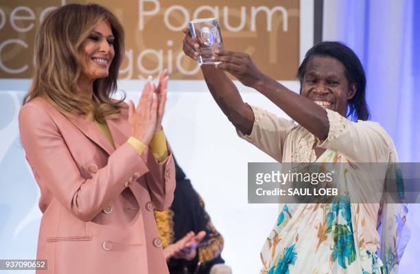 First Lady Melania Trump presents a 2018 International Women of Courage Award to Godelieve Mukasarasi of Rwanda during the Award Ceremony at the...