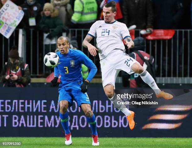 Anton Zabolotny of Russia vies for the ball with Miranda of Brazil during the International friendly match between Russia and Brazil at Luzhniki...