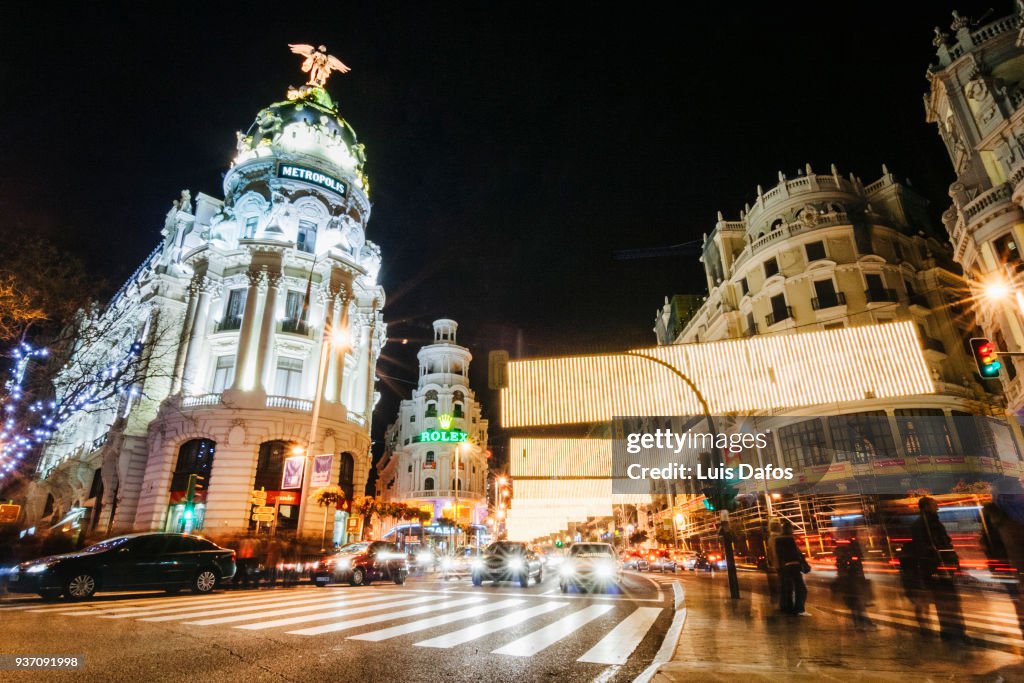 Illuminated Gran Via and Metropolis building.