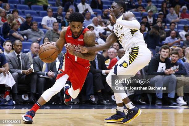 Larry Drew II of the New Orleans Pelicans drives against Darren Collison of the Indiana Pacers during the first half at the Smoothie King Center on...