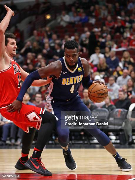 Paul Millsap of the Denver Nuggets drives against Paul Zipser of the Chicago Bulls at the United Center on March 21, 2018 in Chicago, Illinois. The...