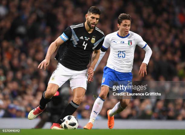 Federico Fazio of Argentina runs with the ball under pressure from Federico Chiesa of Italy during the International friendly match between Italy and...
