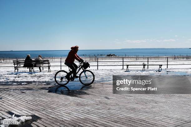 Person rides along the Coney Island boardwalk on a spring afternoon on March 23, 2018 in New York City. Following weeks of cold, snow and ice, New...