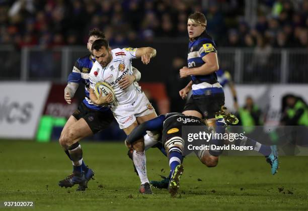 Phil Dollman of Exeter Chiefs is tackled by Matt Garvey and Nathan Charles of Bath during the Aviva Premiership match between Bath Rugby and Exeter...