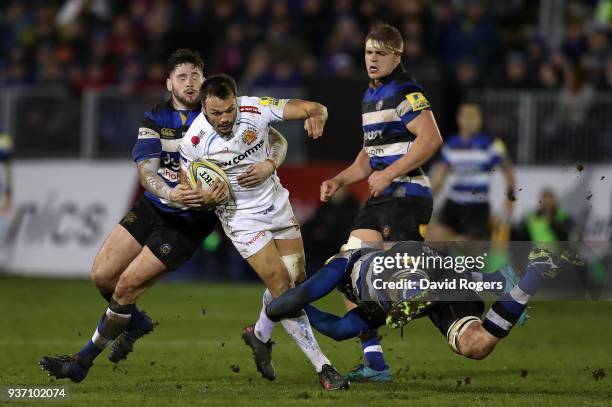 Phil Dollman of Exeter Chiefs is tackled by Matt Garvey and Nathan Charles of Bath during the Aviva Premiership match between Bath Rugby and Exeter...