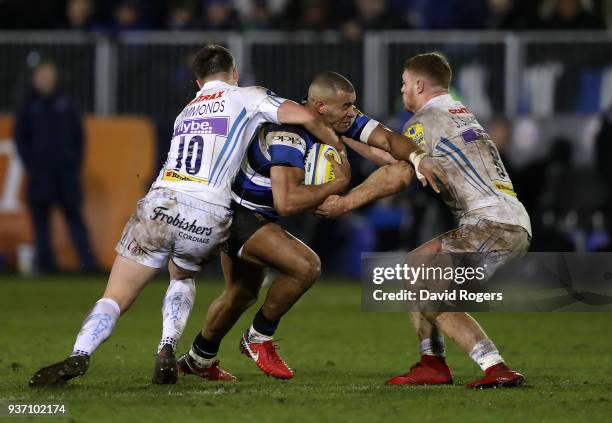Jonathan Joseph of Bath is tackled by Joe Simmonds and Sam Simmonds of Exeter Chiefs during the Aviva Premiership match between Bath Rugby and Exeter...
