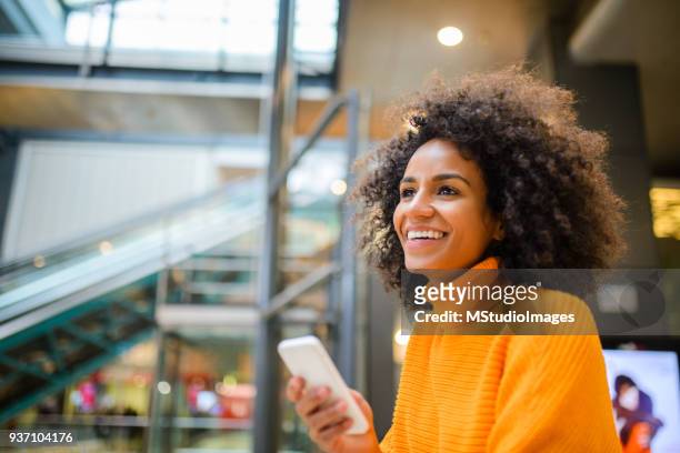 smiling woman using mobile phone. - voice search stock pictures, royalty-free photos & images