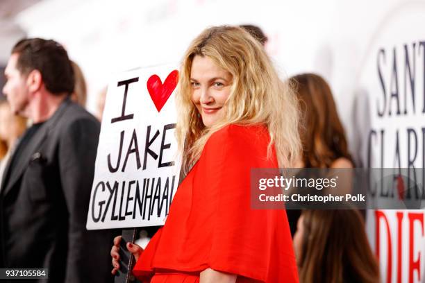 Drew Barrymore holds a sign that says "I love Jake Gyllenhaal" as she walked the carpet at Netflix's 'Santa Clarita Diet' Season 2 Premiere at The...