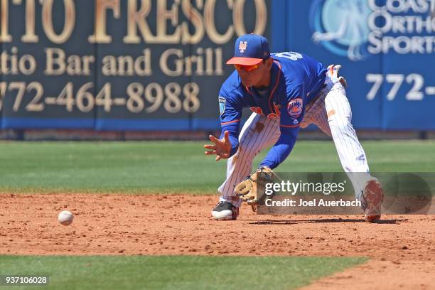 Andres Gimenez of the New York Mets fields the ball hit by Francisco Pena of the St Louis Cardinals during the fifth inning of a spring training game...