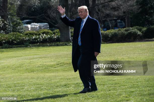 President Donald Trump waves as he departs the White House towards Marine One in Washington, DC on March 23, 2018 heading to Andrews Air Force Base...