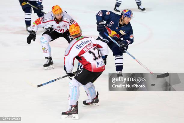 Kevin Lavallee of Pinguins Bremerhaven vies Mads Christensen of Red Bull Munich during the DEL Playoff Quarterfinal match 5 between the EHC Red Bull...