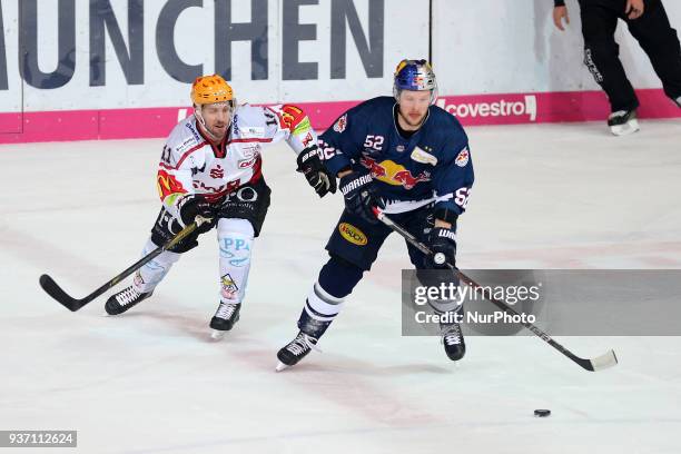 Kris Newbury of Pinguins Bremerhaven vies Patrick Hager of Red Bull Munich during the DEL Playoff Quarterfinal match 5 between the EHC Red Bull...