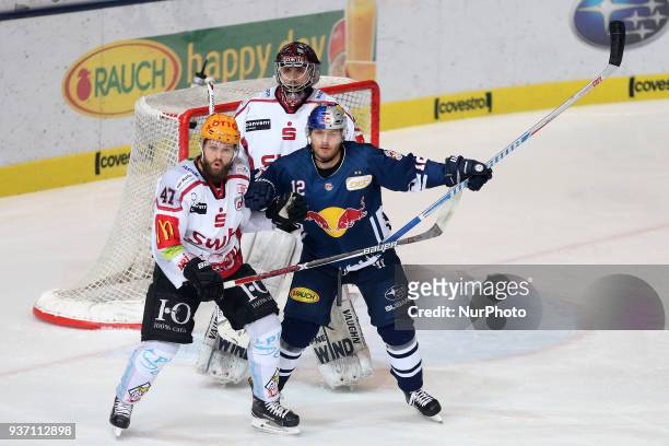 Wade Bergman of Pinguins Bremerhaven vies Mads Christensen of Red Bull Munich during the DEL Playoff Quarterfinal match 5 between the EHC Red Bull...