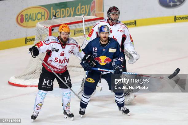 Wade Bergman of Pinguins Bremerhaven vies Mads Christensen of Red Bull Munich during the DEL Playoff Quarterfinal match 5 between the EHC Red Bull...