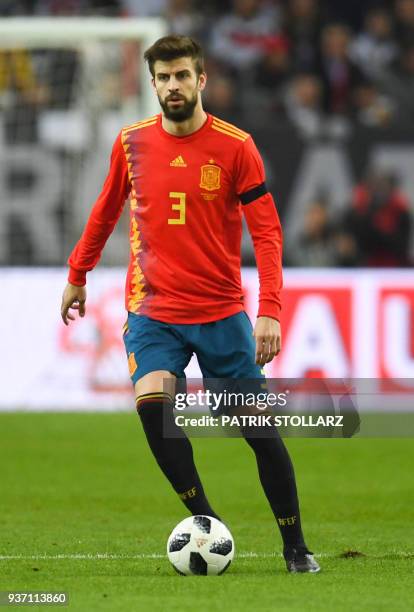 Spain's defender Gerard Pique runs with the ball during the international friendly football match of Germany vs Spain in Duesseldorf, western...