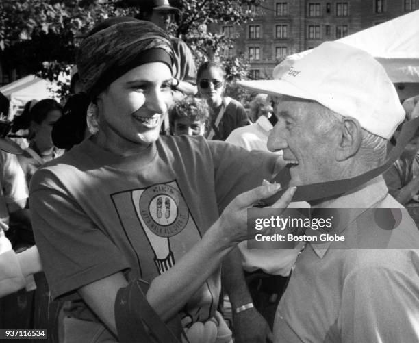 Johnny Kelley, right, receives a medal at the finish line of the Jimmy Fund Walk in Boston, Oct. 9, 1994.