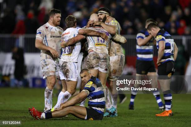 The Exeter Chiefs players celebrate victory at the final whistle as Jonathan Joseph of Bath sits dejected during the Aviva Premiership match between...