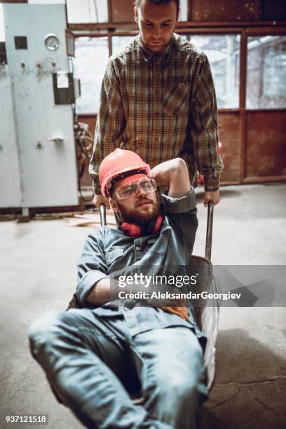 workers having fun and driving with concrete trolley in factory - dirty construction worker stock pictures, royalty-free photos & images