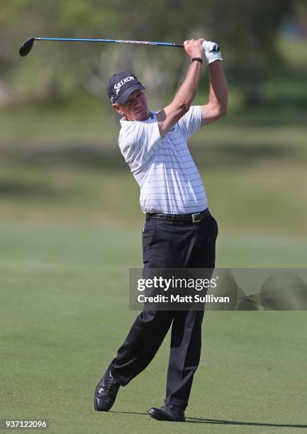 Larry Mize watches his second shot on the 18th hole during the first round of the Rapiscan Systems Classic at Fallen Oak Golf Course on March 23,...