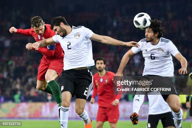 Portugal's forward Cristiano Ronaldo scores a second goal next to Egypt's defender Ahmed El Mohamady and Egypt's defender Ahmed Hegazi during an...
