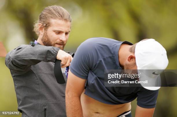 Kevin Chappell of the United States has his back taped on the eighth tee during the third round of the World Golf Championships-Dell Match Play at...