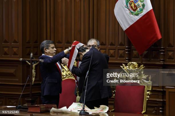 Congressman Luis Galarreta, left, places a sash around Martin Vizcarra, Peru's president, during a swearing in ceremony in Lima, Peru, on Friday,...