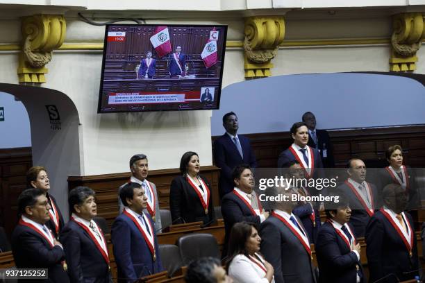 Members of congress stand for the national anthem during Martin Vizcarra, Peru's president, not pictured, swearing in ceremony in Lima, Peru, on...