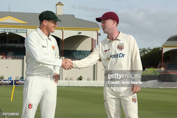 Tasmania captain George Bailey and QLD captain Jimmy Peirson shake hands after Tasmania won the toss during day two of the Sheffield Shield Final...