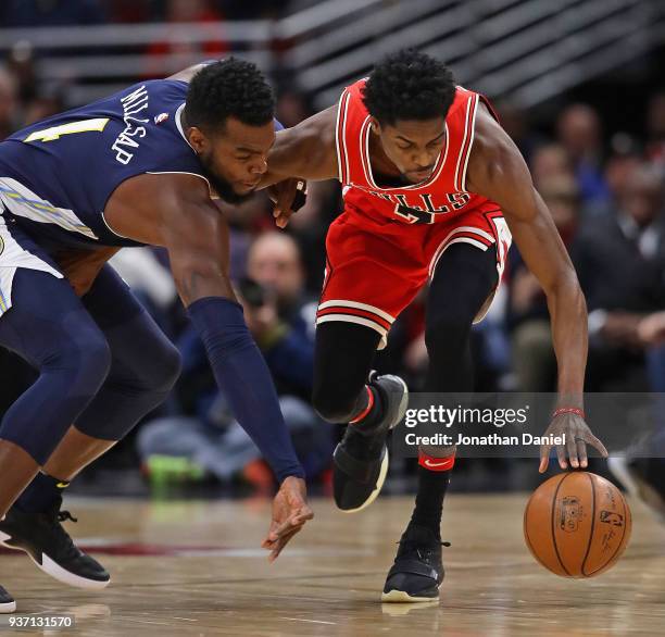 Paul Millsap of the Denver Nuggets and Justin Holiday of the Chicago Bulls battle for a loose ball at the United Center on March 21, 2018 in Chicago,...