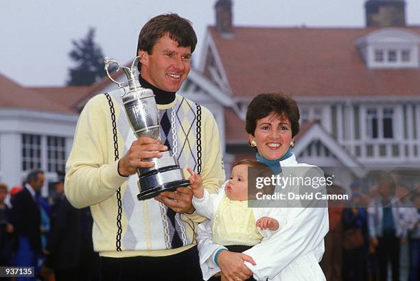 Nick Faldo of England holds the Claret Jug alongside his family, wife Gill and baby Natalie, after winning the British Open at Muirfield in Scotland....