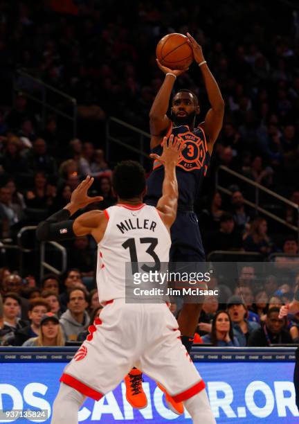 Tim Hardaway Jr. #3 of the New York Knicks in action against Malcolm Miller of the Toronto Raptors at Madison Square Garden on March 11, 2018 in New...