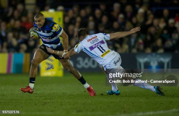 Bath Rugby's Jonathan Joseph evades the tackle of Exeter Chiefs' Lachlan Turner during the Aviva Premiership match between Bath Rugby and Exeter...