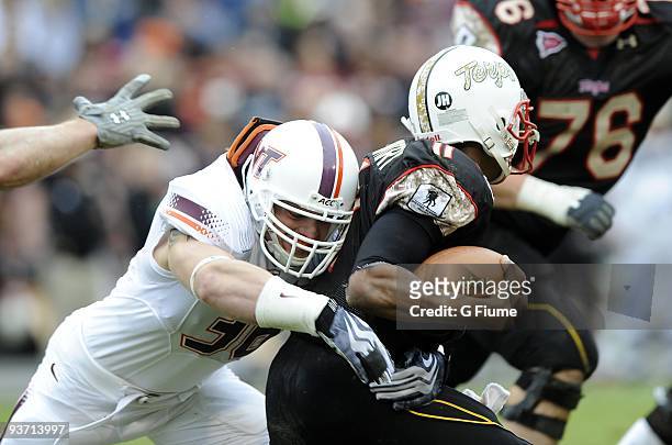 Jake Johnson of the Virginia Tech Hokies tackles Jamarr Robinson of the Maryland Terrapins November 14, 2009 at Byrd Stadium in College Park,...