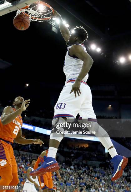 Udoka Azubuike of the Kansas Jayhawks dunks the ball against Aamir Simms of the Clemson Tigers in the 2018 NCAA Men's Basketball Tournament Midwest...