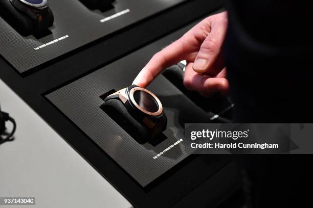 Visitor points a TAG Heuer Connected Watch 45 displayed at the BaselWolrd watch fair on March 23, 2018 in Basel, Switzerland. The annual watch trade...