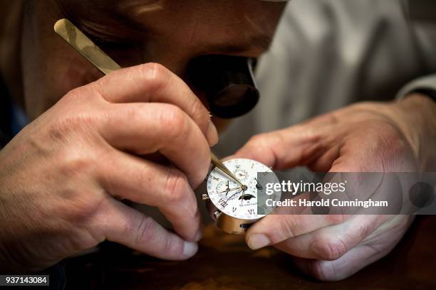 Watchmaker moves a watch hands on the Blancpain booth at the BaselWolrd watch fair on March 23, 2018 in Basel, Switzerland. The annual watch trade...