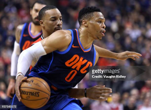 Russell Westbrook of the Oklahoma City Thunder dribbles the ball as Norman Powell of the Toronto Raptors defends during the first half of an NBA game...