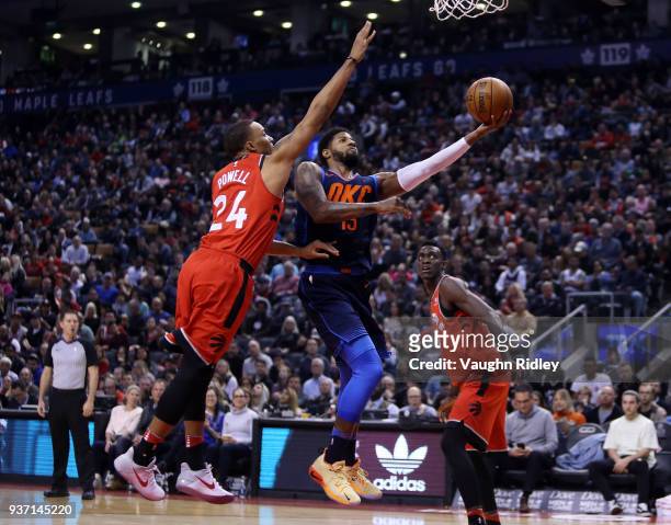 Paul George of the Oklahoma City Thunder shoots the ball as Norman Powell of the Toronto Raptors defends during the first half of an NBA game at Air...