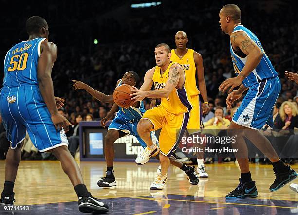 Jordan Farmar of the Los Angeles Lakers dribbles into the paint as he is chased by Darren Collison of the New Orleans Hornets at Staples Center on...