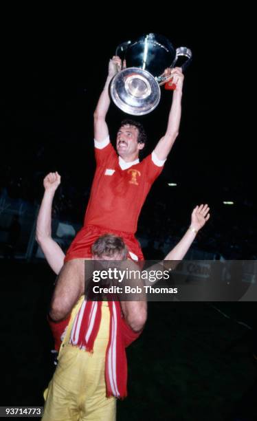The scorer of Liverpool's winning goal, Alan Kennedy, and the trophy are carried by a Liverpool fan after the Liverpool v Real Madrid European Cup...