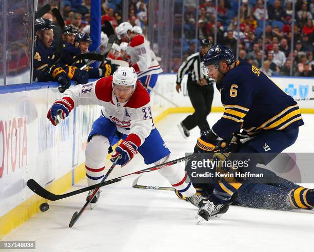 Brendan Gallagher of the Montreal Canadiens and Marco Scandella of the Buffalo Sabres go after a loose puck during the first period at KeyBank Center...