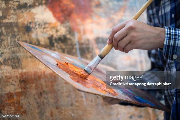 artist using drawing brushes. - malerleinwand stock-fotos und bilder