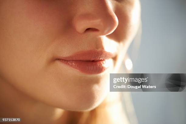 close up of female mouth and nose. - lippen stock-fotos und bilder