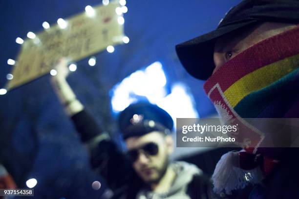Man with rainbow-altered Polish emblem on his scarf during strike against restrictions in Abortion Law in Warsaw on March 23, 2018.