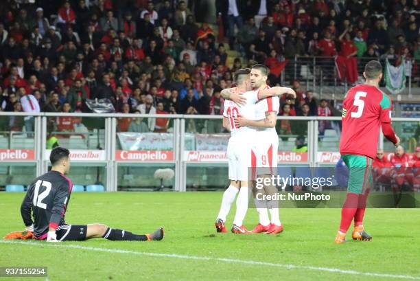 Dusan Tadic celebrates with teammates after scouring during the international friendly football match between Marocco and Serbia at Olympic Grande...